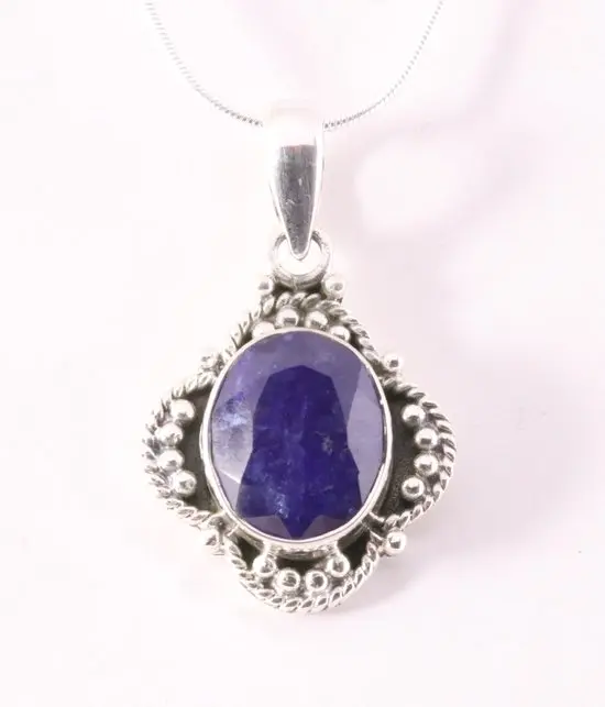 Bewerkte zilveren hanger met blauwe saffier aan ketting